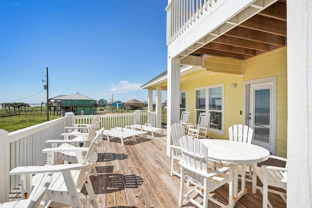 wooden terrace featuring outdoor dining area