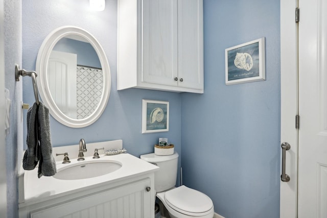 bathroom with toilet and vanity