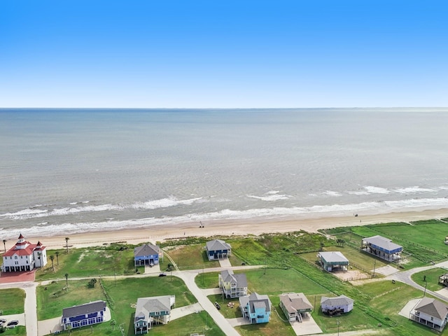 drone / aerial view featuring a view of the beach and a water view