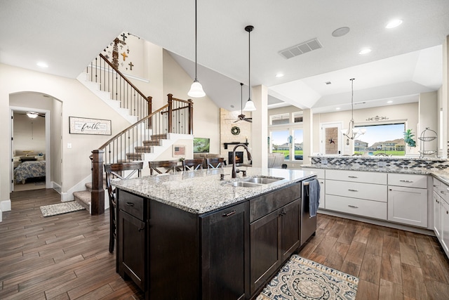 kitchen with a ceiling fan, visible vents, arched walkways, a sink, and dishwasher