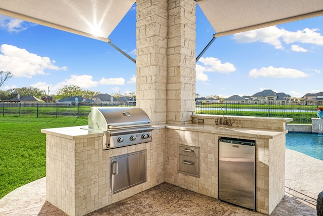 view of patio with area for grilling, a residential view, and fence