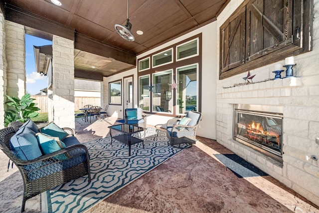 view of patio featuring an outdoor living space with a fireplace