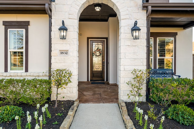 doorway to property featuring stone siding