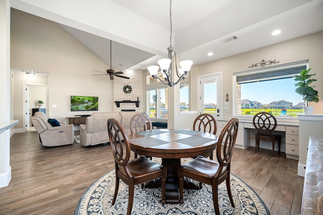 dining area featuring recessed lighting, visible vents, light wood-style floors, and high vaulted ceiling