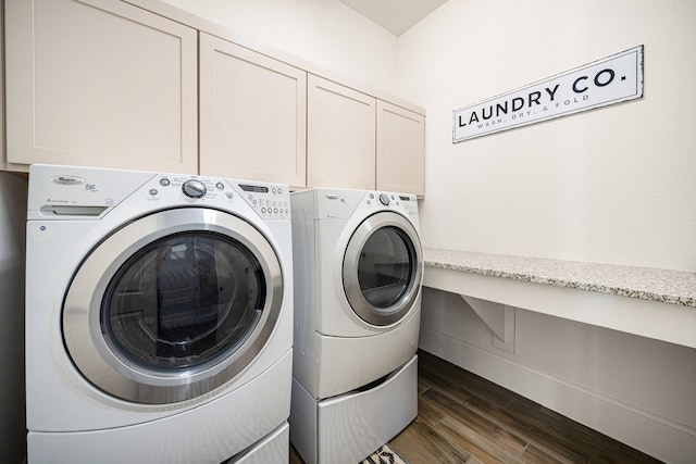 clothes washing area with cabinet space, separate washer and dryer, and dark wood finished floors