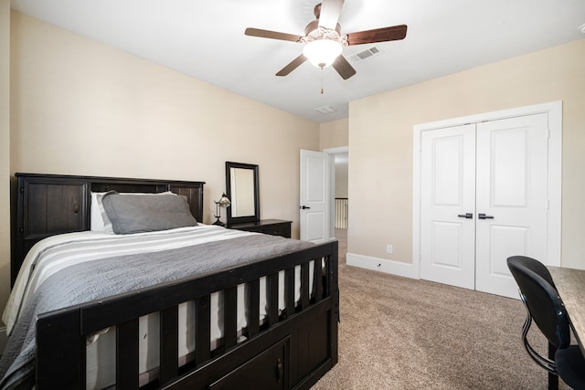 bedroom with visible vents, light carpet, a ceiling fan, a closet, and baseboards