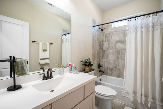 full bathroom with visible vents, toilet, vanity, and shower / bath combination with curtain