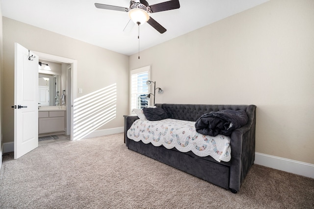 sitting room featuring baseboards, carpet floors, and a ceiling fan