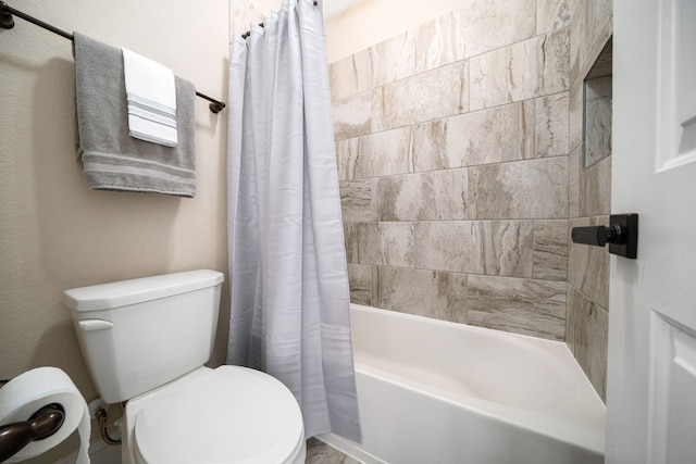 bathroom with shower / tub combo and toilet