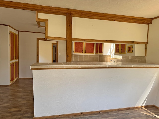 kitchen with tile countertops, decorative backsplash, and dark wood-style floors