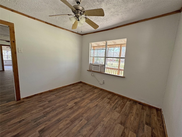 spare room featuring cooling unit, wood finished floors, ceiling fan, a textured ceiling, and crown molding