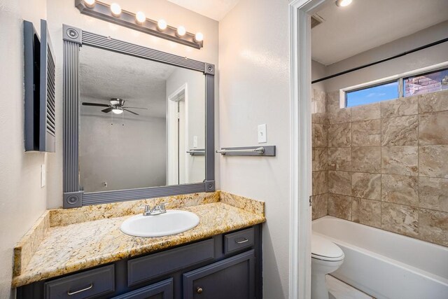 bathroom with vanity, toilet, washtub / shower combination, and ceiling fan