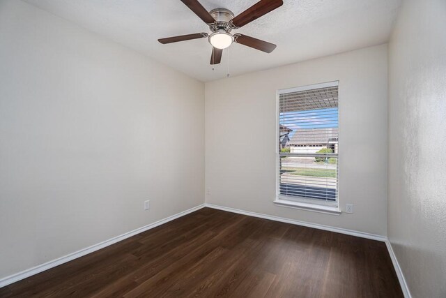 spare room with ceiling fan, baseboards, and wood finished floors