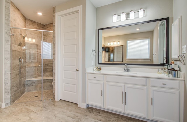 full bath with a stall shower and vanity