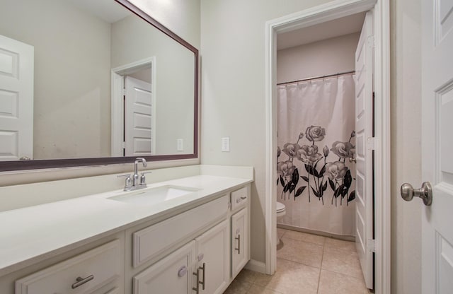 bathroom with vanity, curtained shower, toilet, and tile patterned flooring