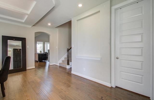 interior space with baseboards, stairs, hardwood / wood-style floors, recessed lighting, and arched walkways