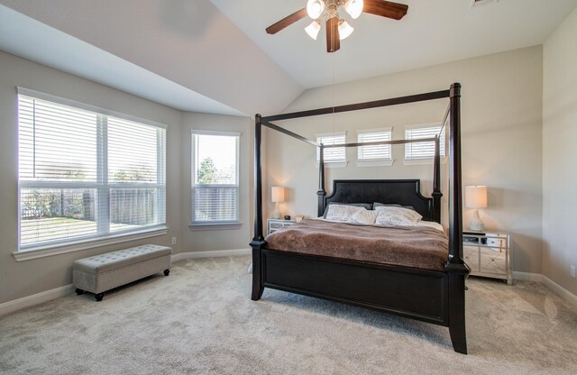 carpeted bedroom featuring vaulted ceiling, baseboards, and ceiling fan