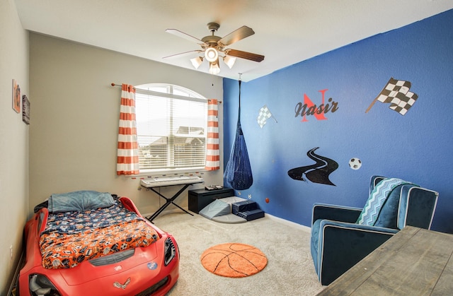 carpeted bedroom featuring baseboards and ceiling fan