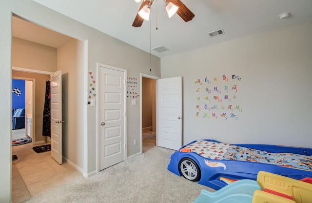 bedroom with visible vents, a ceiling fan, and carpet