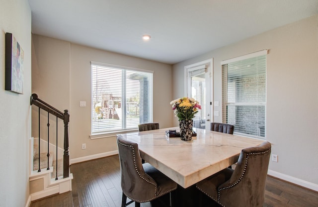 dining room featuring stairs, dark wood-style floors, and baseboards