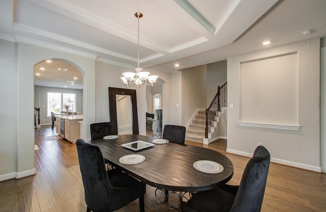 dining space with stairway, arched walkways, baseboards, and hardwood / wood-style flooring