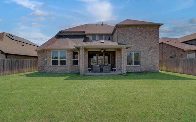 back of property featuring a fenced backyard, a yard, an outdoor hangout area, and ceiling fan