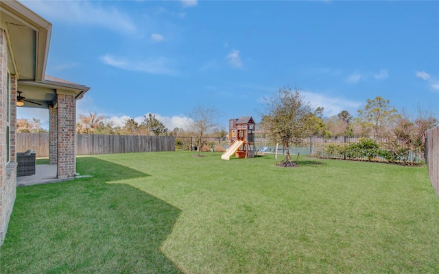 view of yard with a playground and a fenced backyard