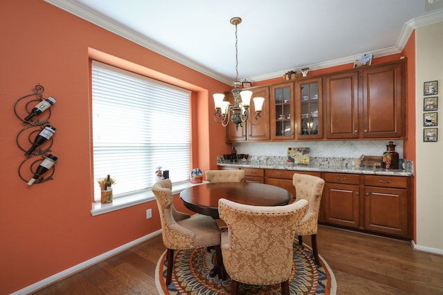 9407 Thurber Ridge Dr, Spring, TX 77379 - dining area featuring ornamental molding, dark wood finished floors, baseboards, and a chandelier