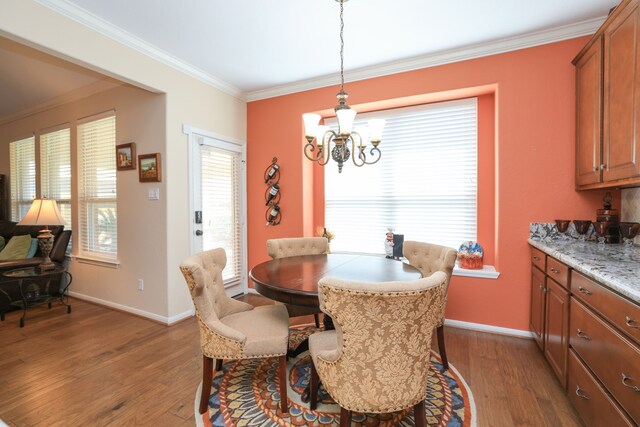 9407 Thurber Ridge Dr, Spring, TX 77379 - living room featuring a ceiling fan, wood finished floors, a glass covered fireplace, ornamental molding, and built in shelves