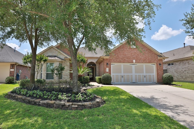 9407 Thurber Ridge Dr, Spring, TX 77379 - view of front of house featuring driveway, a garage, a front yard, and brick siding
