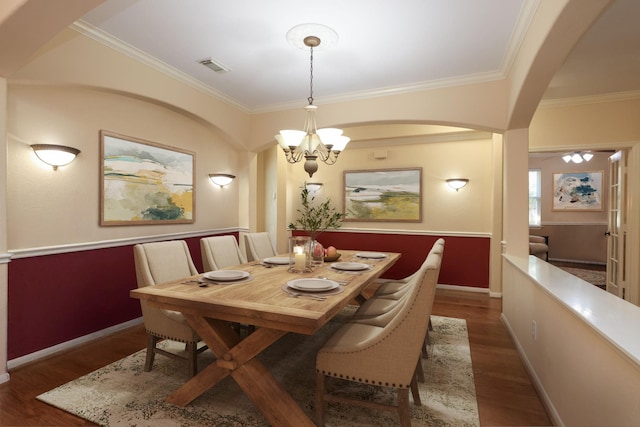 9407 Thurber Ridge Dr, Spring, TX 77379 - dining area with a chandelier, crown molding, wood finished floors, arched walkways, and baseboards