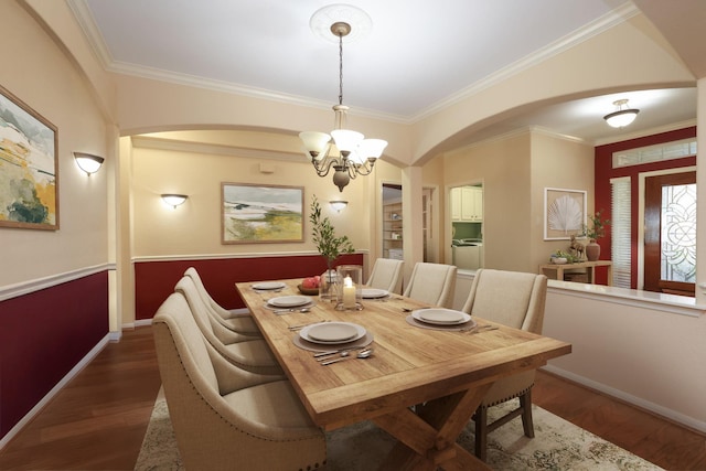 9407 Thurber Ridge Dr, Spring, TX 77379 - dining room featuring arched walkways, a chandelier, crown molding, baseboards, and dark wood-type flooring