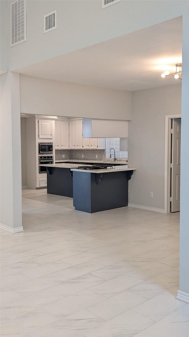 kitchen with visible vents, marble finish floor, and stainless steel appliances