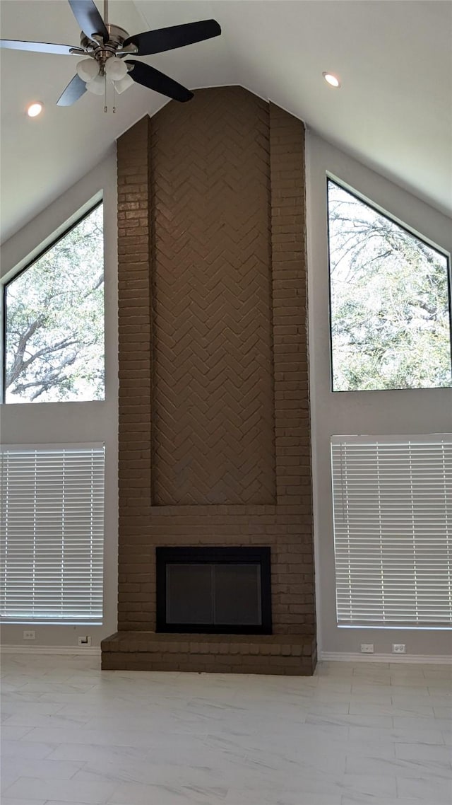 unfurnished living room featuring high vaulted ceiling, marble finish floor, a ceiling fan, recessed lighting, and a fireplace