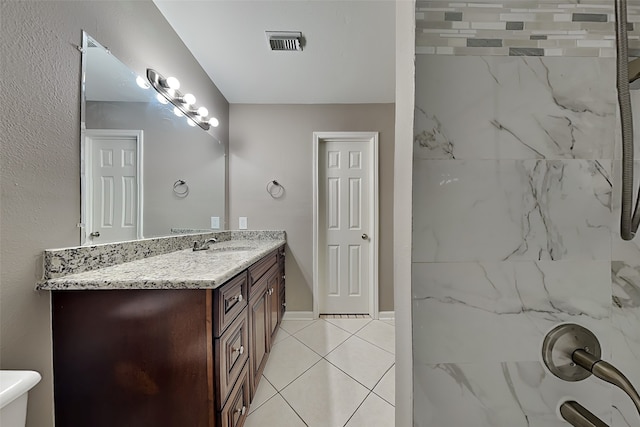 bathroom with vanity, a shower, visible vents, and tile patterned flooring