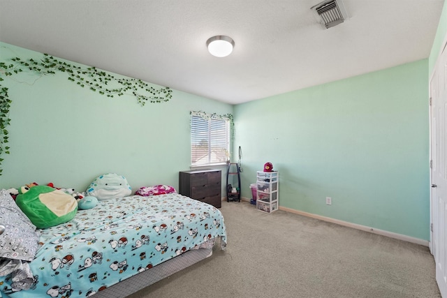 bedroom featuring visible vents, baseboards, and carpet floors