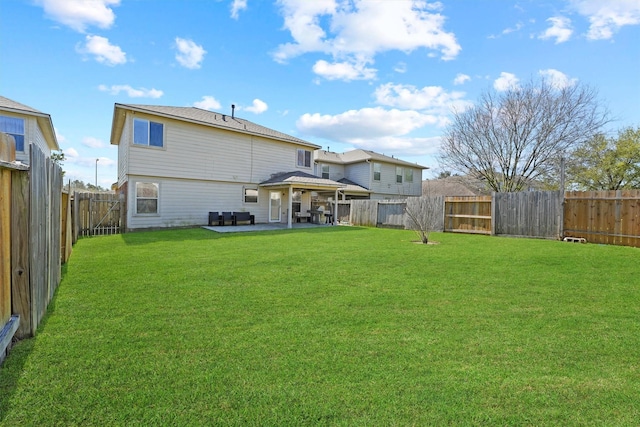 back of house with a patio, a yard, and a fenced backyard