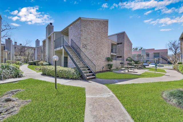 surrounding community featuring stairway and a yard