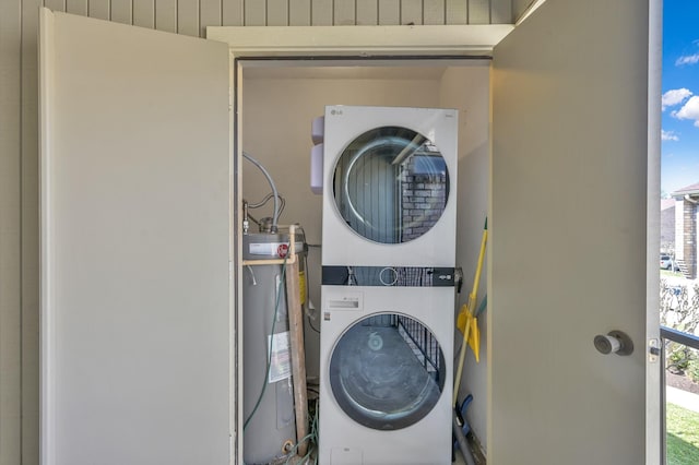 washroom with plenty of natural light, stacked washer and clothes dryer, laundry area, and water heater