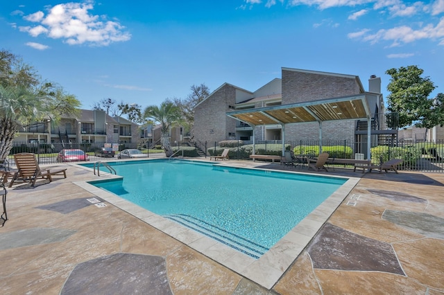 pool featuring a patio area, a residential view, and fence