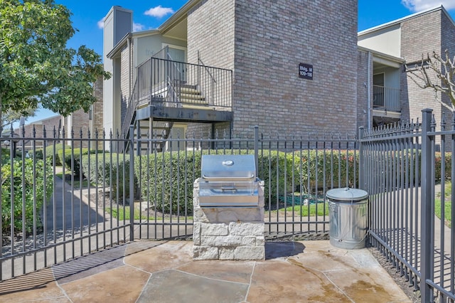 exterior space with fence and a grill