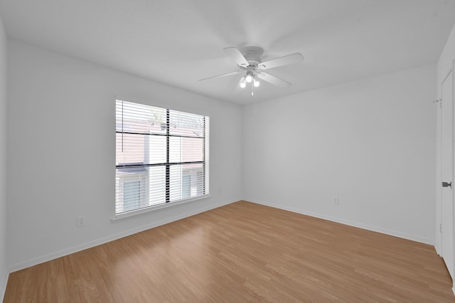 unfurnished room with baseboards, a ceiling fan, and light wood finished floors