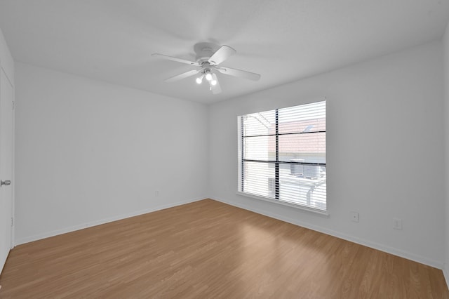 unfurnished room with light wood-style flooring, baseboards, and ceiling fan