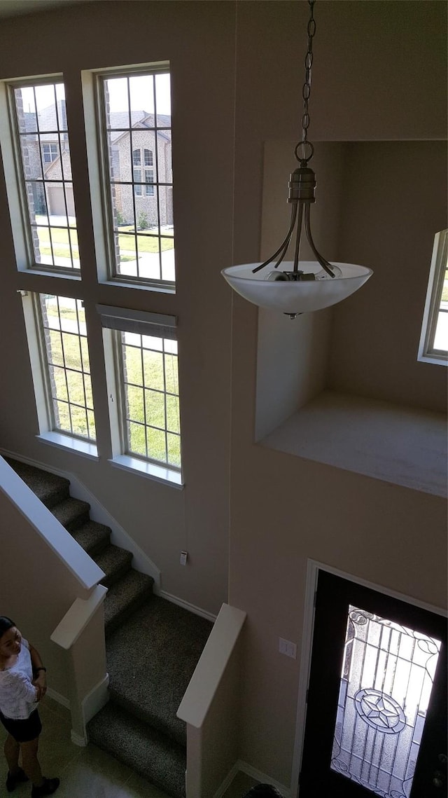 stairs featuring a high ceiling