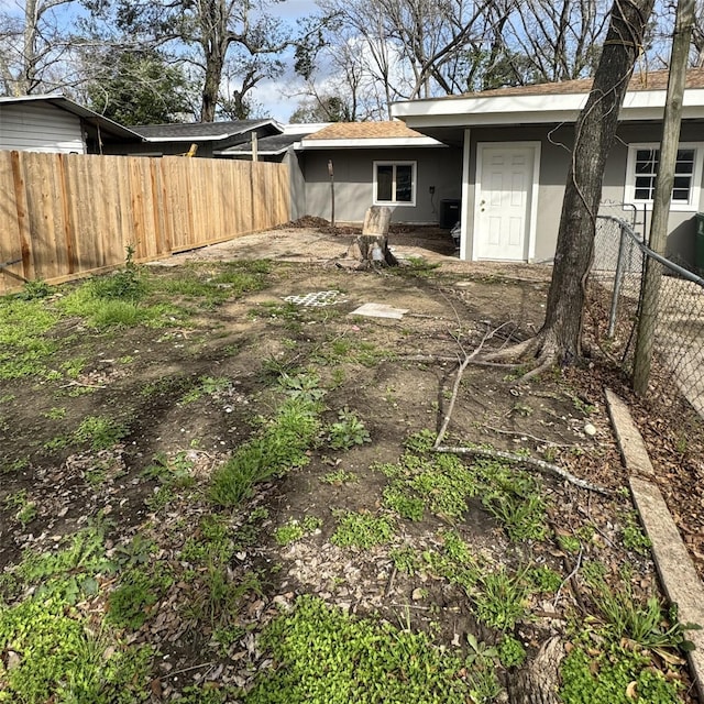 back of property with fence and stucco siding