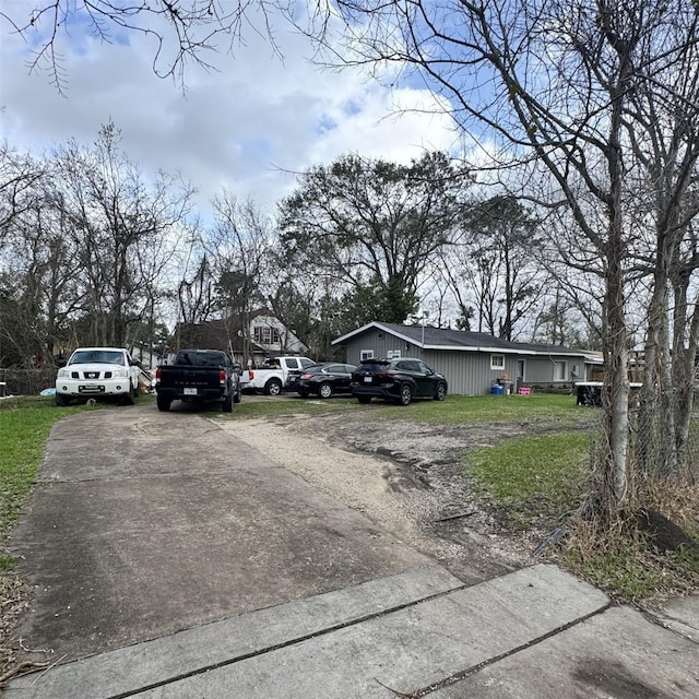 view of road featuring concrete driveway