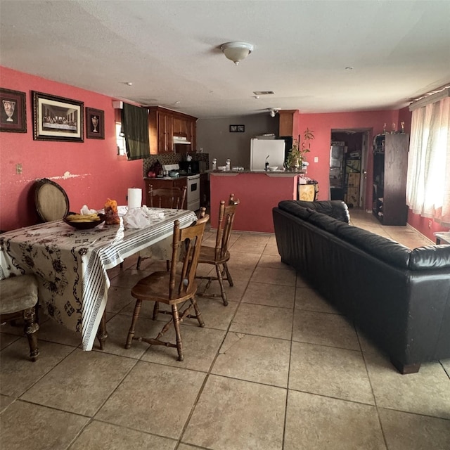 dining space featuring light tile patterned floors and visible vents