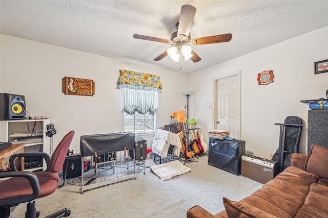 carpeted home office featuring a textured ceiling and a ceiling fan