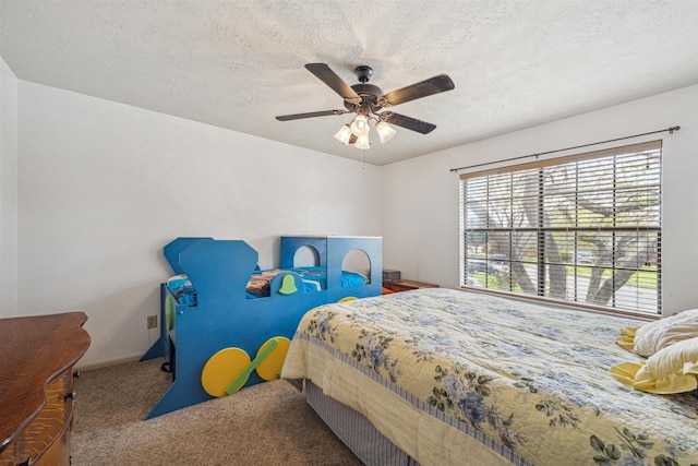 bedroom with a ceiling fan, baseboards, carpet floors, and a textured ceiling