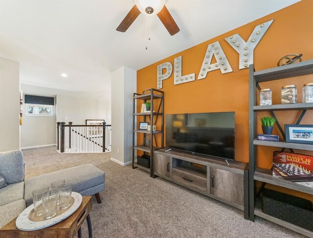 living area with ceiling fan and carpet flooring